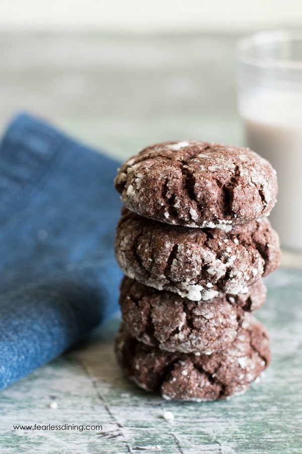 a stack of four brookie cookies next to a blue denim napkin