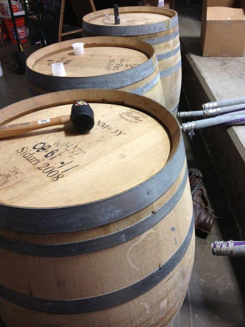 A row of wine barrels at a winery cellar.