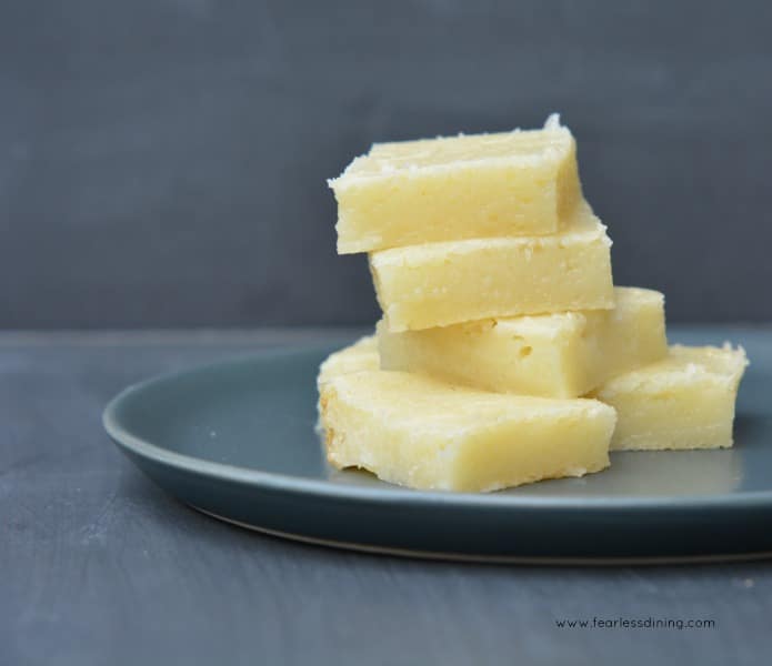 Hawaiian Bata - Hawaiian Butter Mochi squares stacked on a grey plate.