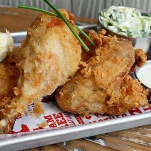 gluten free fried chicken on a plate, garnished with chives