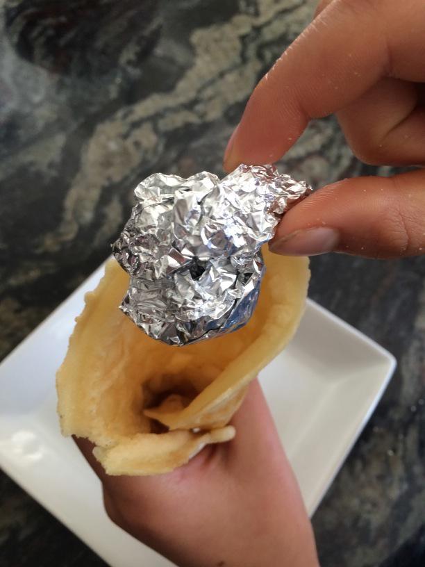 Adding foil to the inside of a rolled gluten free waffle cone to keep it propped open.