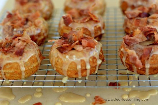Gluten Free Mini Maple Bacon Donuts on an icing rack.