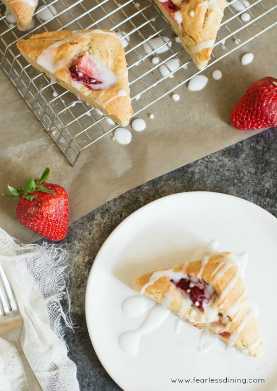 Top view of gluten free strawberry scones on a plate and a rack