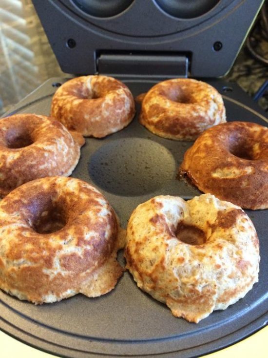 Cooked donuts that are cooked and in the donut maker.