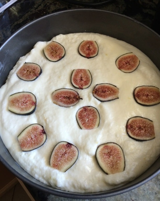 The lemon yogurt cake batter in a springform pan with fresh figs on top.