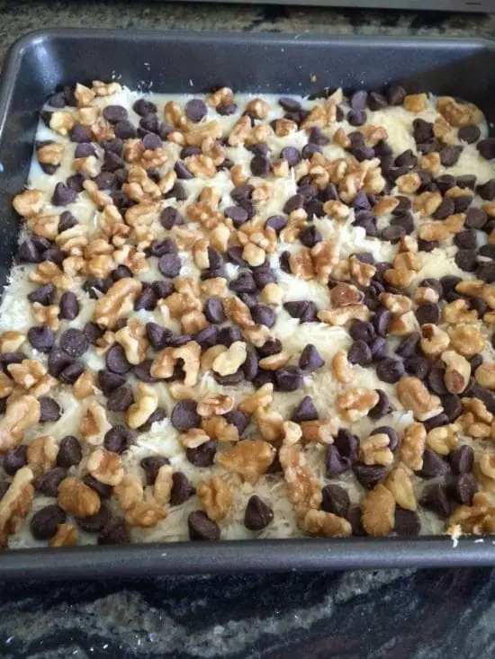 Adding walnuts and chips to the magic bars