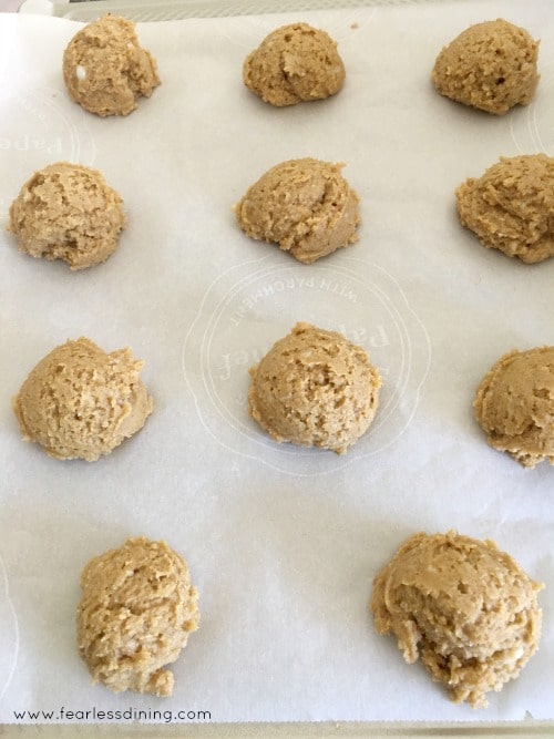 Gluten free pumpkin cookie dough balls ready to bake on a baking sheet.