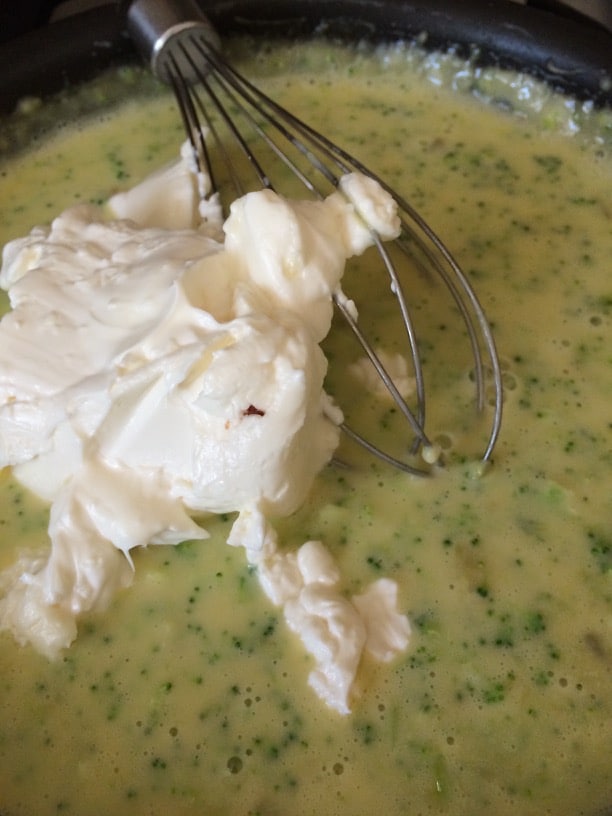 Adding cream cheese to souffle base.