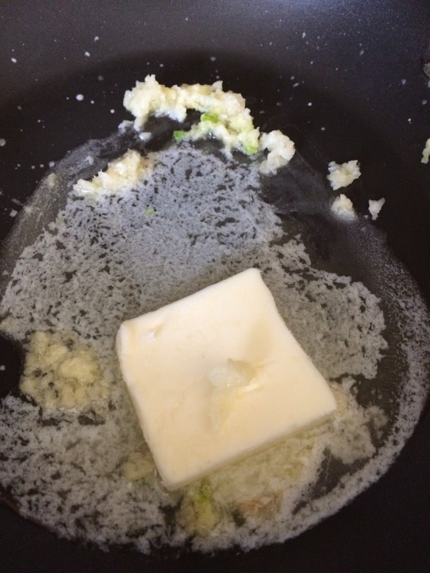 Butter and garlic cooking in a pan.