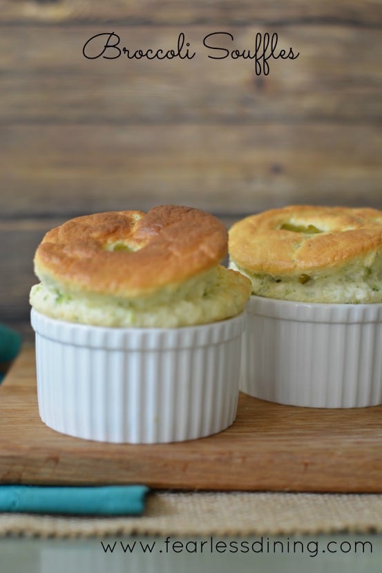 Two gluten free souffles on a cutting board.