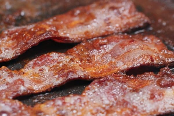 A picture of the bacon cooking in a pan