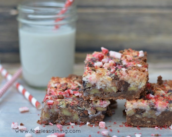 Three gluten free peppermint 7 layer bars stacked on top of each other.
