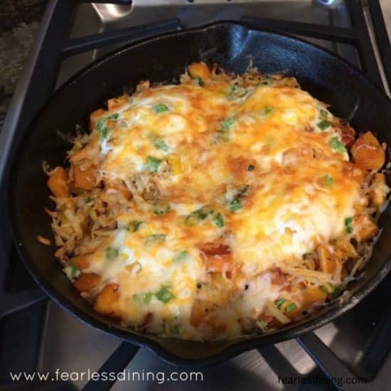 A cooked butternut squash breakfast skillet in a cast iron pan.