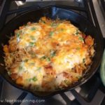 A skillet filled with cooked butternut squash and eggs.