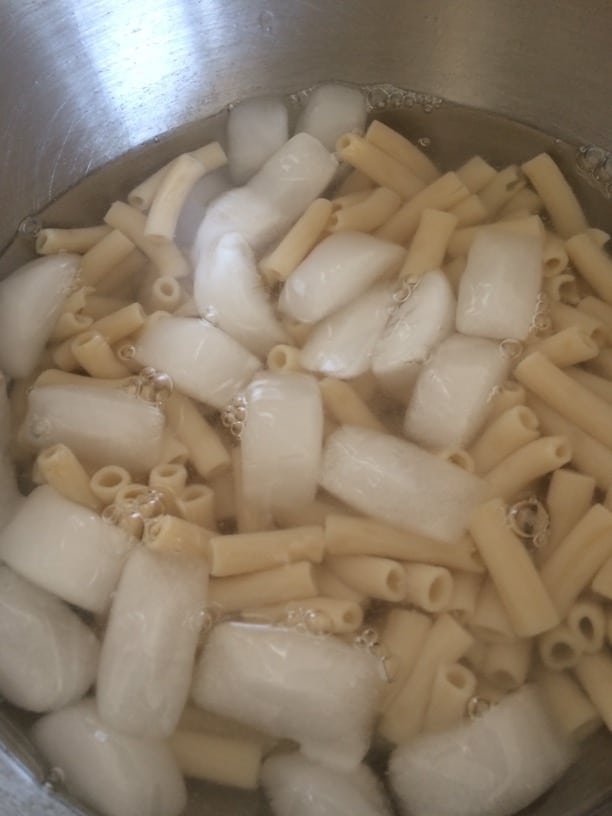 Pasta cooling down in an ice water bath.