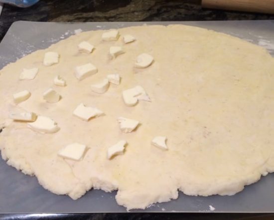 Adding butter to the dough.