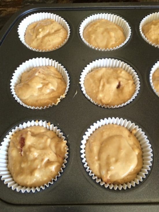 The muffin batter in a muffin tin.