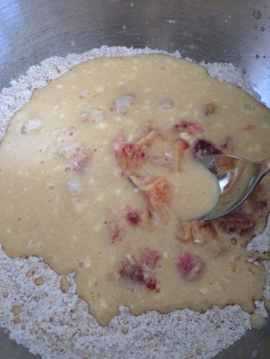 The wet and dry muffin ingredients mixed in a bowl.