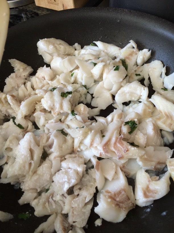 Chopped cooked cod in a pan