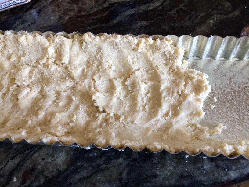 Shaping the pie crust in the tart pan.