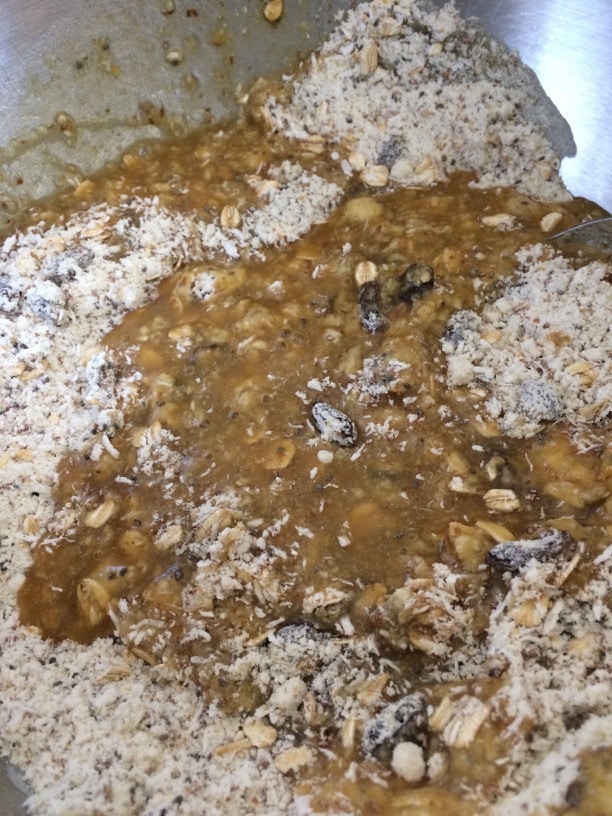 Wet and dry ingredients being mixed for a gluten free donuts recipe.