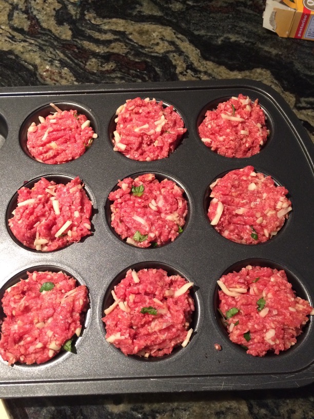 Spread out the meatloaf meat in a muffin tin to bake.