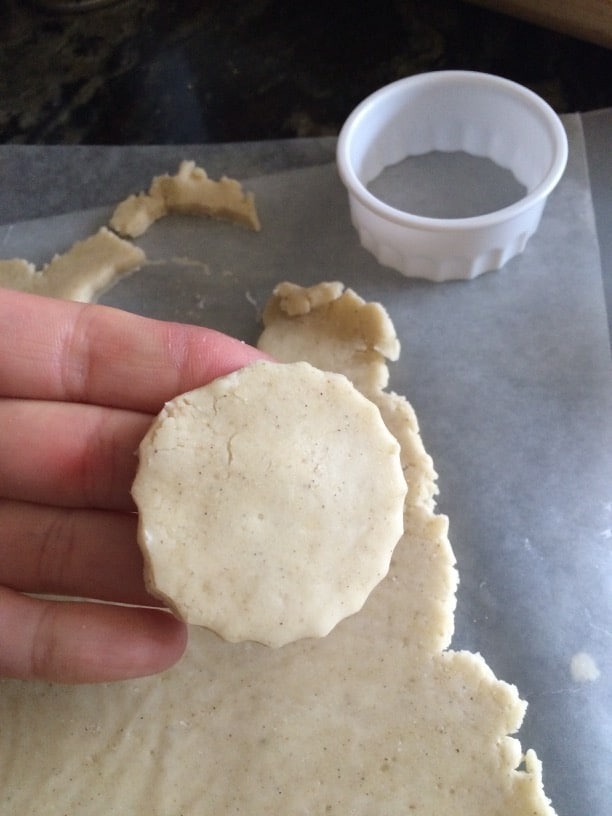 Picking up a cannoli dough circle cutout.