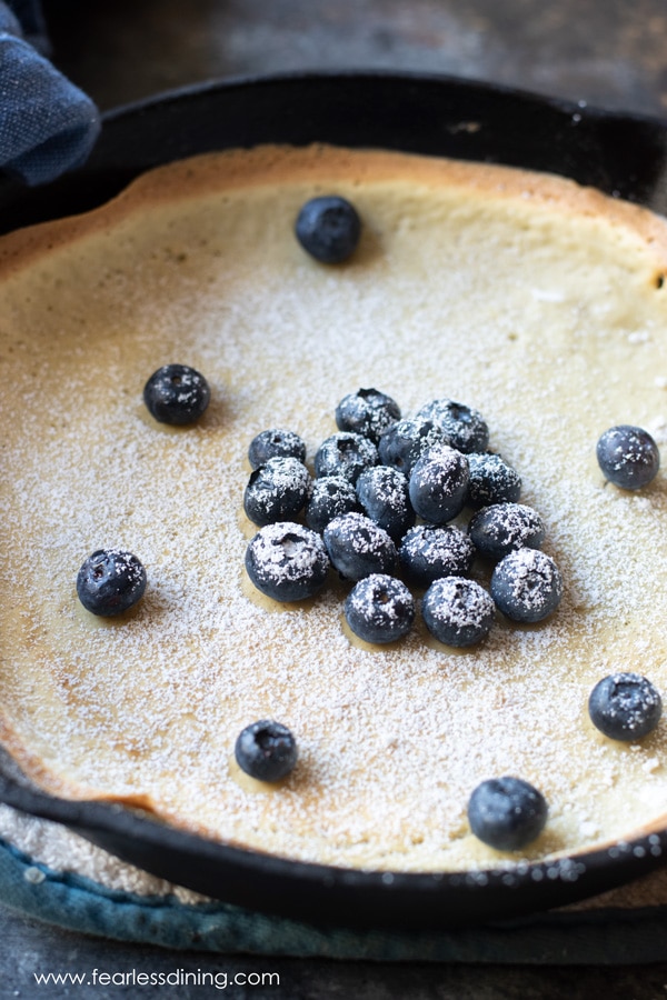 another view of the blueberry topped gluten free dutch baby pancake in the skillet
