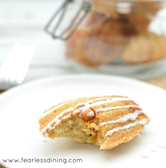 Gluten Free Butterscotch Madeleine cookie with a bite taken out. The cookie is on a plate.