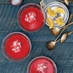 Three bowls of red pepper beet soup.