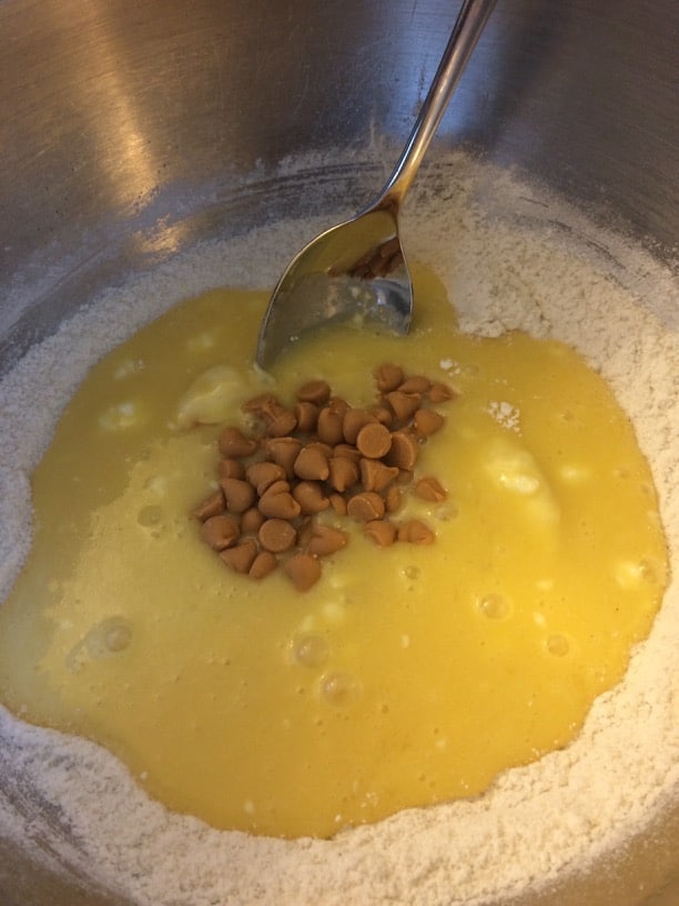 butterscotch madeleine dry ingredients in a bowl with the wet ingredients