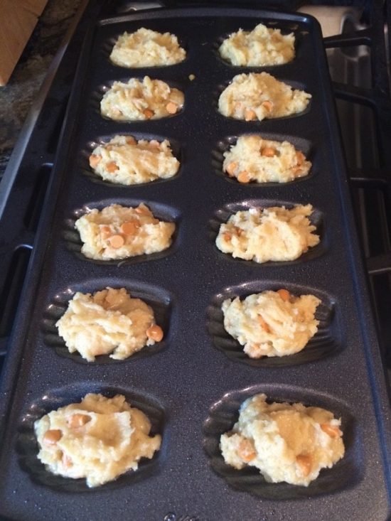 Madeleine batter in a madeleine pan.