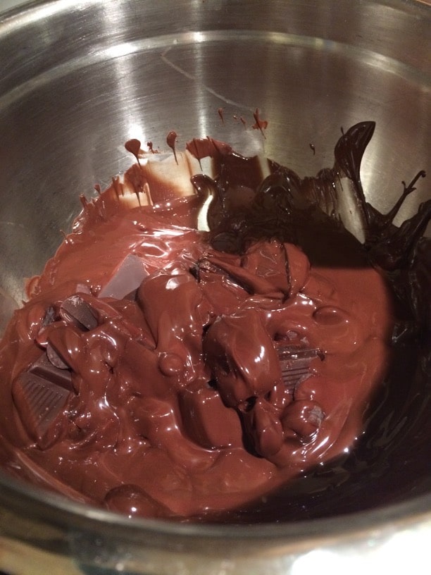Melting chocolate in a bowl over a pot of boiling water.