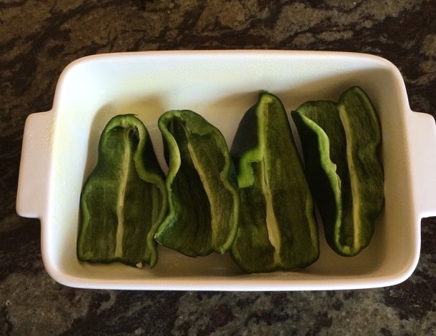 The peppers in a greased casserole dish.