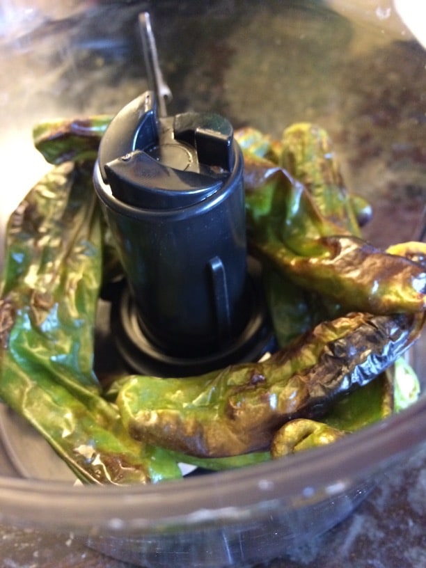Roasted shishito peppers in cuisinart about to be ground up.