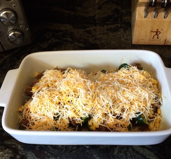 Baked pasilla peppers in a casserole dish ready to bake.