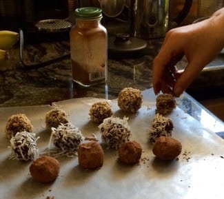 Topping truffles and putting onto wax paper.