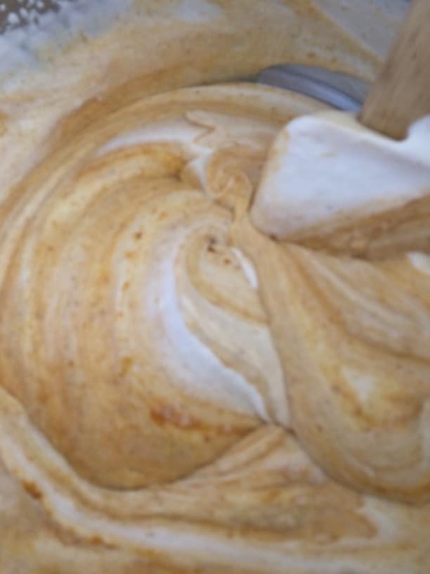 Mixing the pumpkin layer in a mixing bowl.