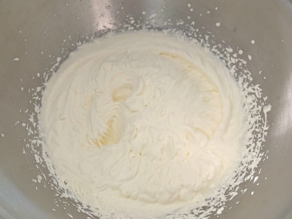 The whipped cream in a mixing bowl.