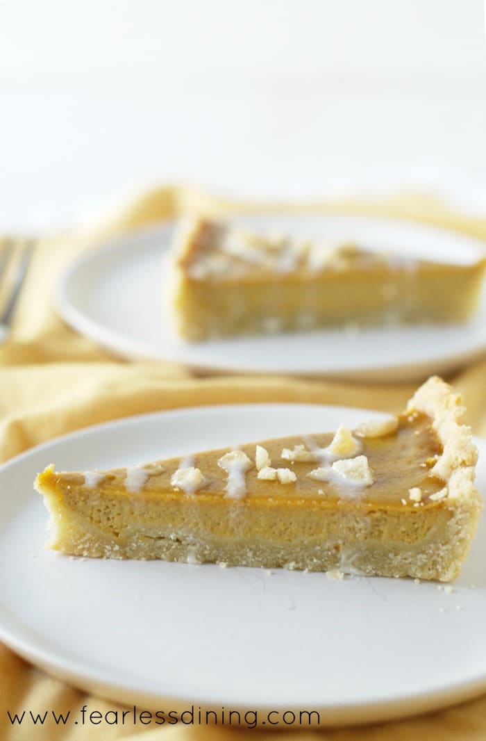 A slice of Gluten Free Butternut Squash Maple Ginger Tart on a plate.