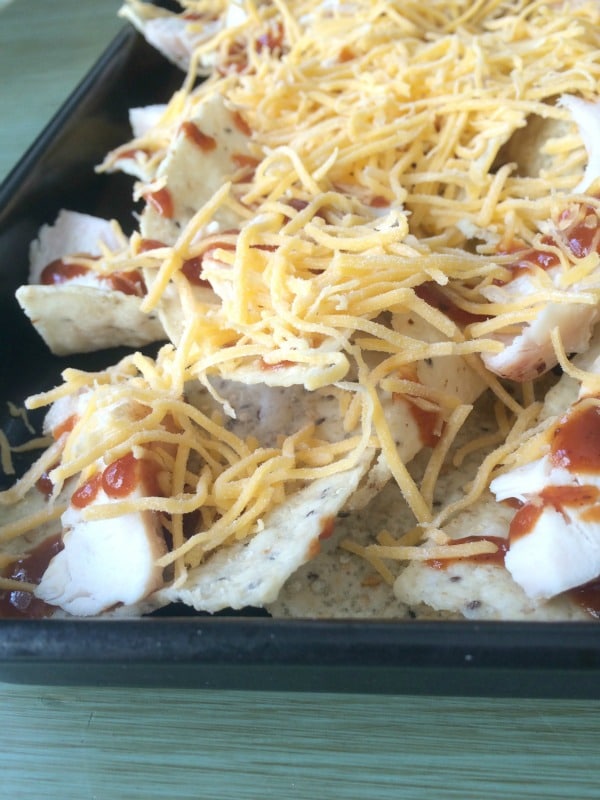 Chicken, Sauce, Cheese on top of chicken nachos.
