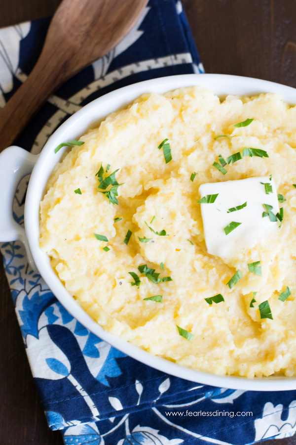 Mashed rutabagas in a dish. There is a pat of butter on top.