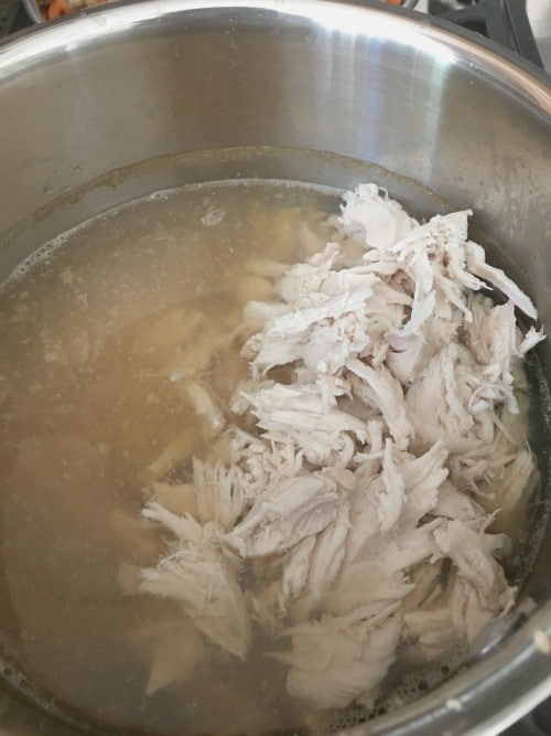 Adding shredded chicken back to Instant Pot.