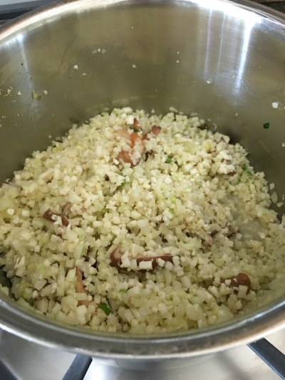 Cauliflowered Rice and Shiitake cooking in a pan.