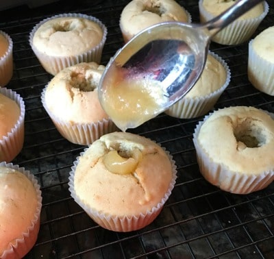 Filling cupcakes with lemon curd.