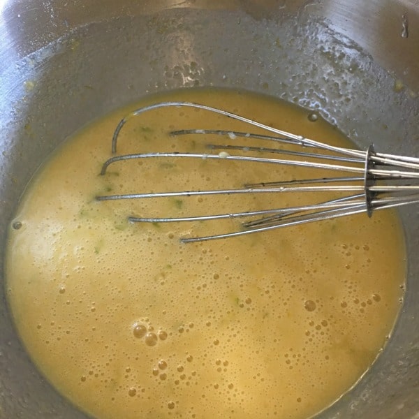 Lime Bar bar batter in a bowl with a whisk in it.