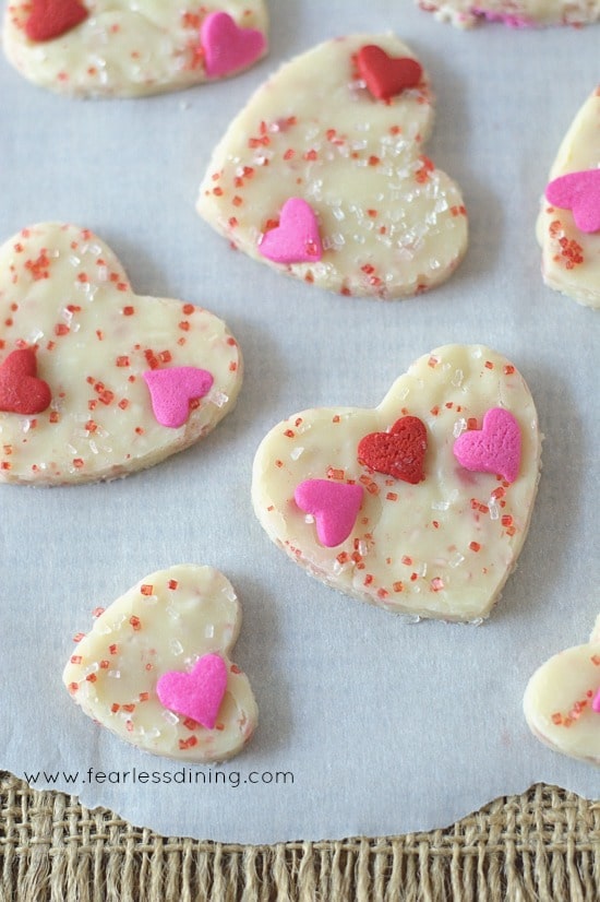 Close up of White Chocolate Fudge Bites. Each has pink and red heart sprinkles on top. 