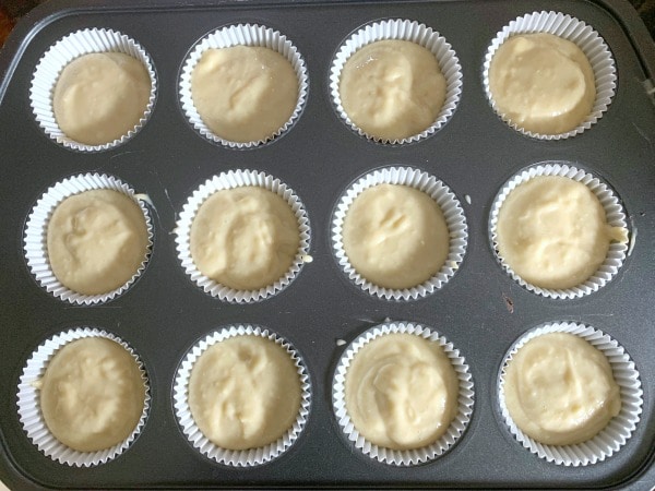 Cupcake batter in a muffin tin ready to bake.