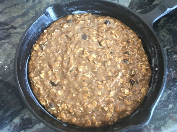 The oatmeal cookie batter in a cast iron skillet.