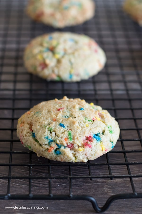 The funfetti cookies on a black cooling rack.